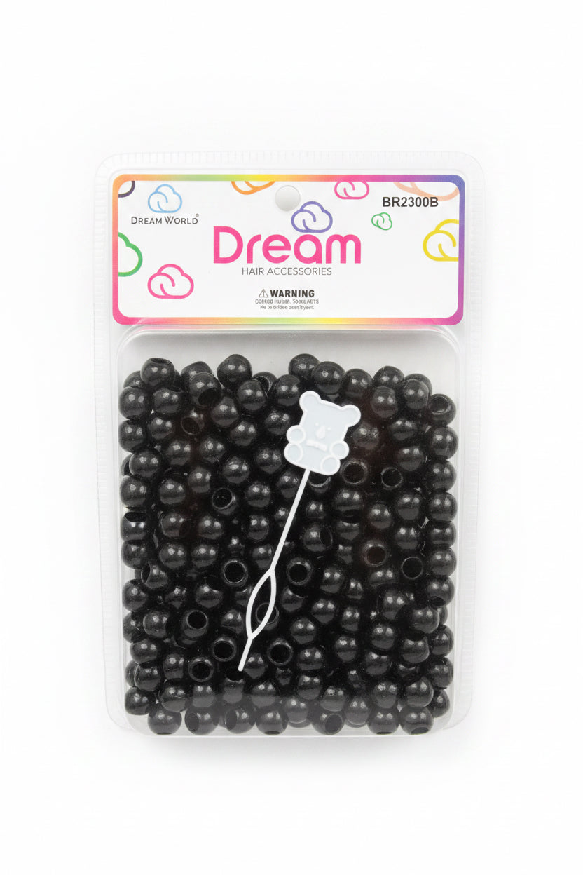 Packaged black beaded hair accessory set from Dream World, containing black beads, brown hair loops, and a white bear-shaped pick, shown in its retail packaging on a store shelf.